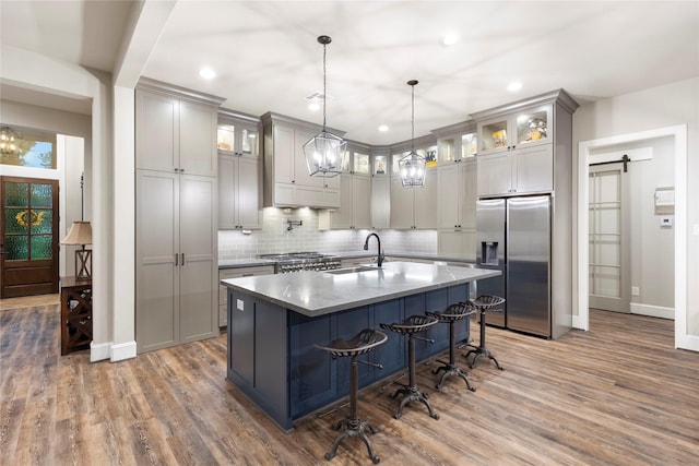 19817 Whispering Creek Trl, Magnolia, TX 77355 - kitchen featuring stainless steel fridge, a sink, baseboards, dark wood finished floors, and recessed lighting