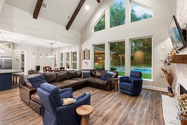 19817 Whispering Creek Trl, Magnolia, TX 77355 - living room with light wood-style floors, high vaulted ceiling, a stone fireplace, beamed ceiling, and recessed lighting