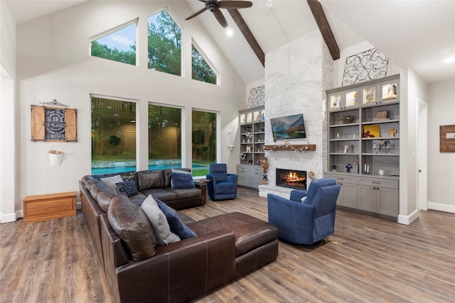 19817 Whispering Creek Trl, Magnolia, TX 77355 - living area with high vaulted ceiling, a fireplace, baseboards, wood finished floors, and ceiling fan