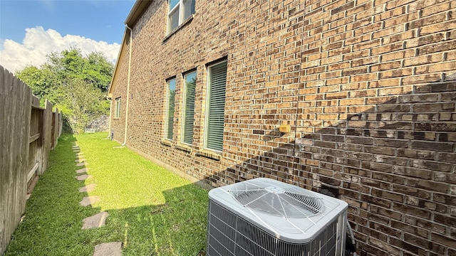 3021 Rocky Point Dr, Pearland, TX 77584 - view of home's exterior featuring cooling unit and brick siding