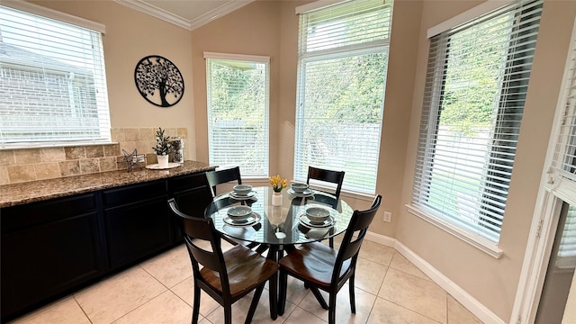 3021 Rocky Point Dr, Pearland, TX 77584 - dining area featuring crown molding, light tile patterned flooring, plenty of natural light, and baseboards
