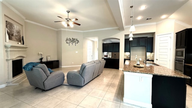 3021 Rocky Point Dr, Pearland, TX 77584 - living area with ceiling fan, arched walkways, a fireplace with raised hearth, light tile patterned floors, and baseboards