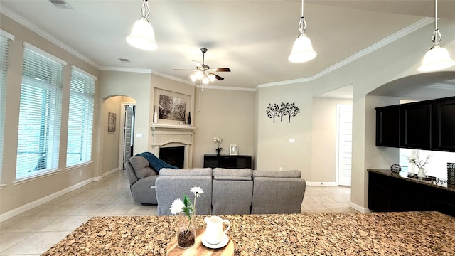 3021 Rocky Point Dr, Pearland, TX 77584 - living area with light tile patterned flooring, arched walkways, a fireplace, ornamental molding, and a ceiling fan