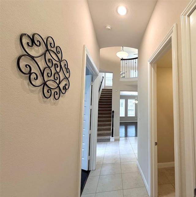 3021 Rocky Point Dr, Pearland, TX 77584 - hallway featuring light tile patterned floors, stairs, and baseboards