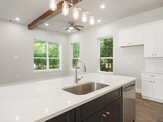 731 Magnolia Point Dr, Houston, TX 77336 - kitchen featuring stainless steel dishwasher, a sink, white cabinetry, plenty of natural light, and recessed lighting