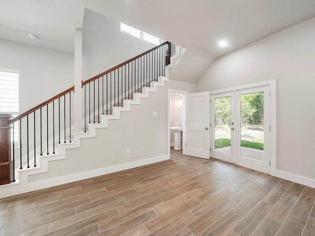 731 Magnolia Point Dr, Houston, TX 77336 - foyer with stairs, baseboards, wood finished floors, vaulted ceiling, and french doors