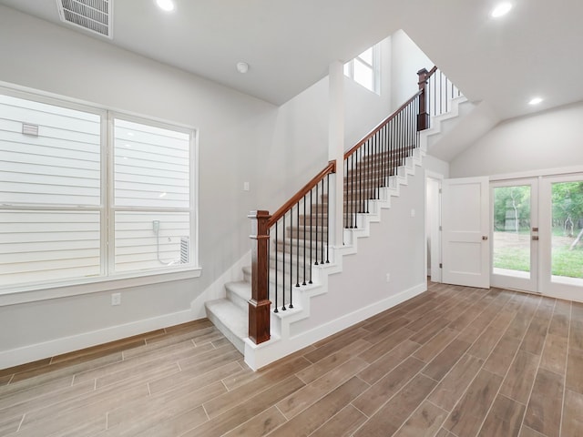 731 Magnolia Point Dr, Houston, TX 77336 - stairs with baseboards, wood finished floors, recessed lighting, and a towering ceiling