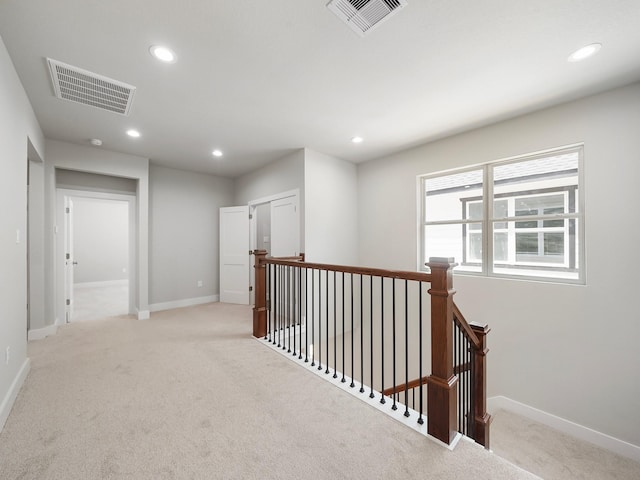 731 Magnolia Point Dr, Houston, TX 77336 - hallway with an upstairs landing, light colored carpet, baseboards, and recessed lighting