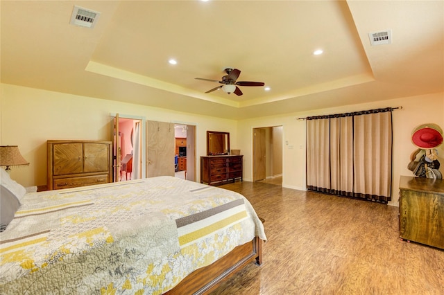 2465 Ryan Dr, Alvin, TX 77511 - bedroom featuring a tray ceiling, wood finished floors, baseboards, recessed lighting, and ceiling fan