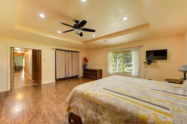 2465 Ryan Dr, Alvin, TX 77511 - bedroom with a raised ceiling, wood finished floors, recessed lighting, ceiling fan, and baseboards