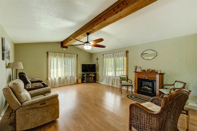 2465 Ryan Dr, Alvin, TX 77511 - living area featuring a fireplace, wood finished floors, ceiling fan, a textured ceiling, and baseboards