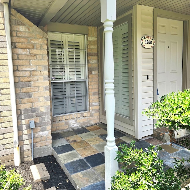 3306 S Greenpark Dr, Houston, TX 77082 - view of exterior entry with a porch and brick siding