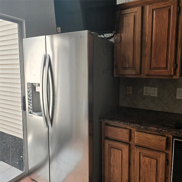 3306 S Greenpark Dr, Houston, TX 77082 - kitchen with stainless steel refrigerator with ice dispenser, tasteful backsplash, and brown cabinets
