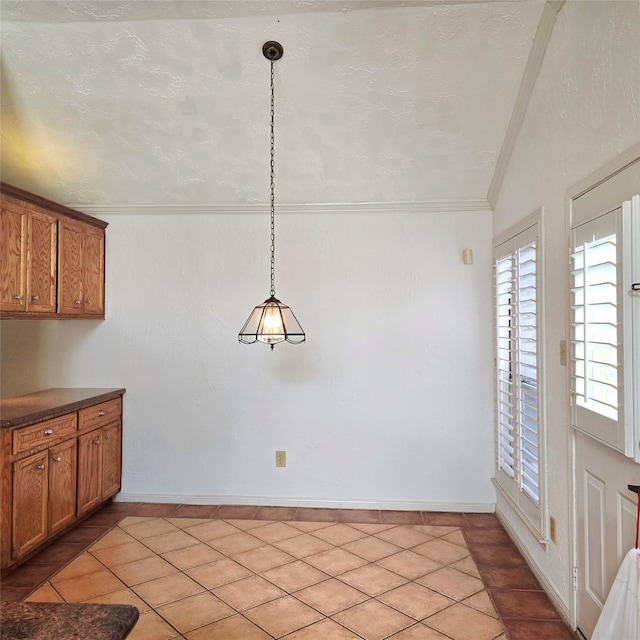 3306 S Greenpark Dr, Houston, TX 77082 - unfurnished dining area featuring lofted ceiling, light tile patterned floors, crown molding, and baseboards