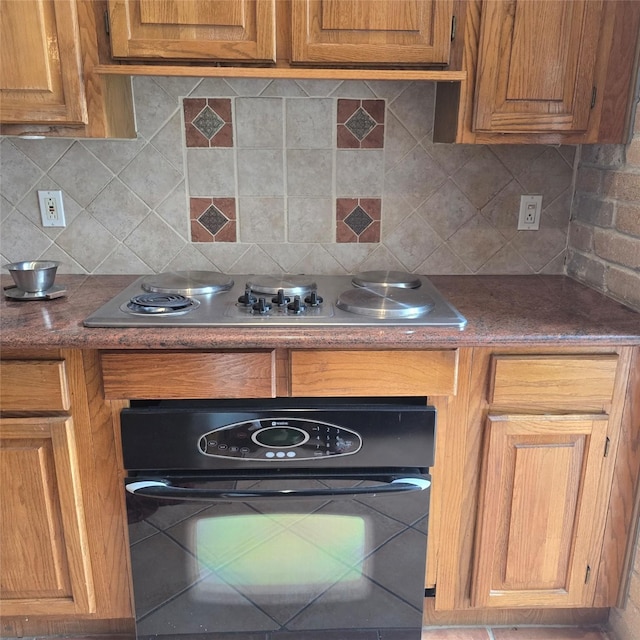 3306 S Greenpark Dr, Houston, TX 77082 - kitchen featuring black oven, stainless steel electric cooktop, tasteful backsplash, and brown cabinetry