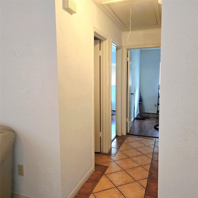 3306 S Greenpark Dr, Houston, TX 77082 - hallway featuring attic access, a textured wall, and light tile patterned flooring