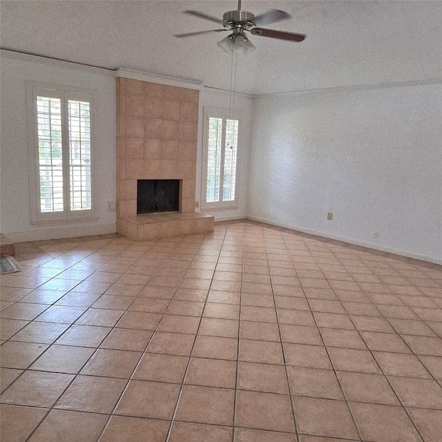 3306 S Greenpark Dr, Houston, TX 77082 - unfurnished living room featuring a ceiling fan, a fireplace, light tile patterned floors, and crown molding