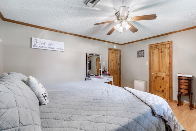 881 County Road 2276, Cleveland, TX 77327 - bedroom featuring light wood-type flooring, a textured ceiling, ornamental molding, and ceiling fan