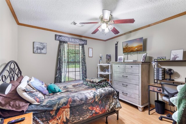 881 County Road 2276, Cleveland, TX 77327 - bedroom featuring light wood-type flooring, a textured ceiling, crown molding, and a ceiling fan