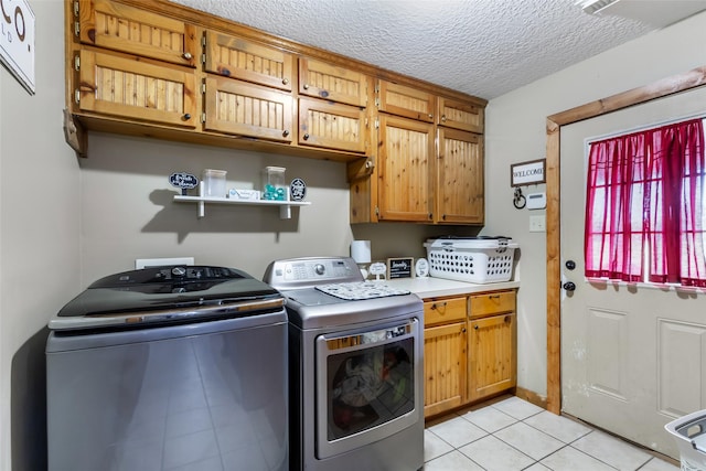 881 County Road 2276, Cleveland, TX 77327 - washroom with cabinet space, washing machine and clothes dryer, light tile patterned floors, and a textured ceiling