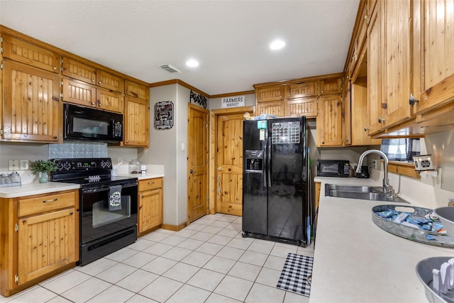 881 County Road 2276, Cleveland, TX 77327 - kitchen featuring black appliances, a sink, light countertops, recessed lighting, and light tile patterned floors