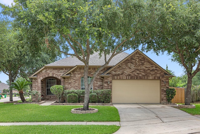 26019 Pagemill Ln, Richmond, TX 77406 - view of front facade featuring brick siding, a garage, driveway, and roof with shingles