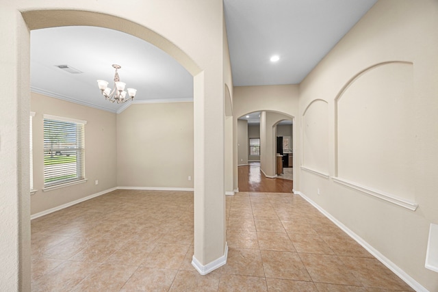 26019 Pagemill Ln, Richmond, TX 77406 - hallway featuring arched walkways, light tile patterned floors, a chandelier, crown molding, and baseboards