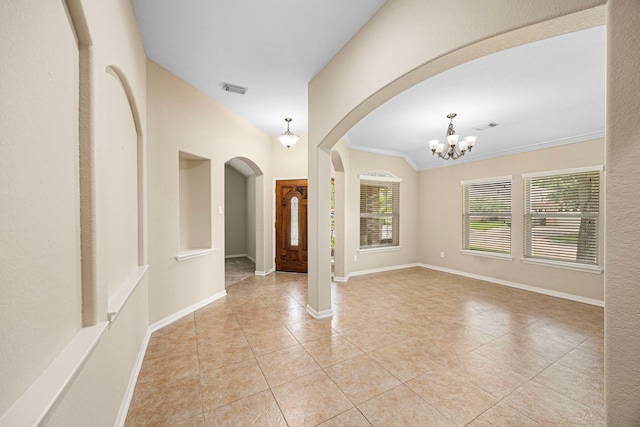 26019 Pagemill Ln, Richmond, TX 77406 - entryway with arched walkways, plenty of natural light, light tile patterned flooring, ornamental molding, and a chandelier