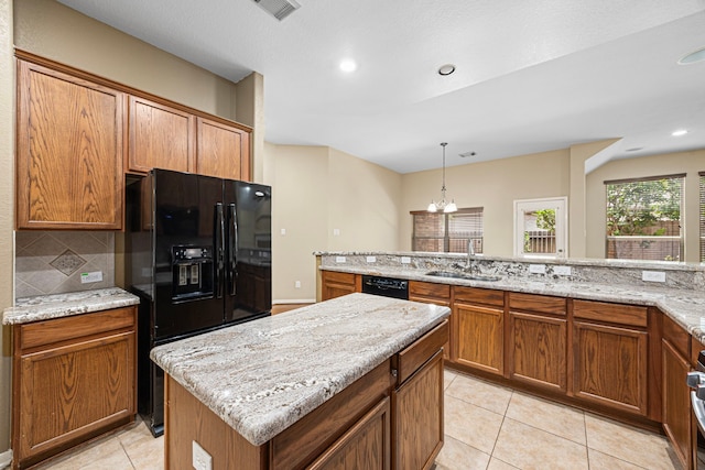 26019 Pagemill Ln, Richmond, TX 77406 - kitchen featuring a sink, black appliances, a kitchen island, light tile patterned flooring, and a chandelier