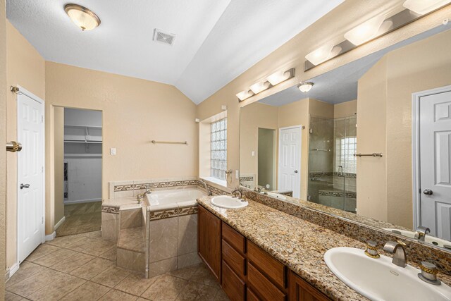26019 Pagemill Ln, Richmond, TX 77406 - full bathroom with a shower stall, a bath, double vanity, lofted ceiling, and tile patterned floors