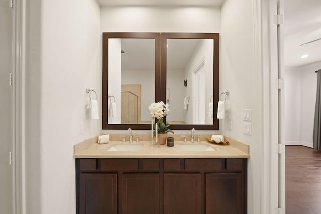 1317 Roy St, Houston, TX 77007 - full bathroom featuring double vanity, a shower with door, and wood finished floors