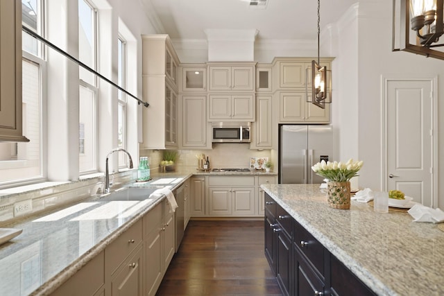 1317 Roy St, Houston, TX 77007 - kitchen featuring stainless steel appliances, crown molding, a sink, light stone counters, and dark wood-style flooring