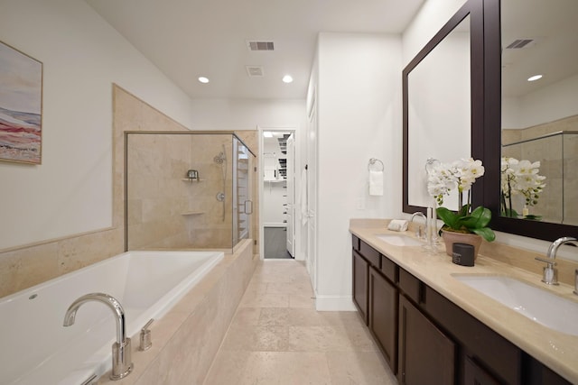 1317 Roy St, Houston, TX 77007 - bathroom with a stall shower, double vanity, a garden tub, recessed lighting, and a walk in closet