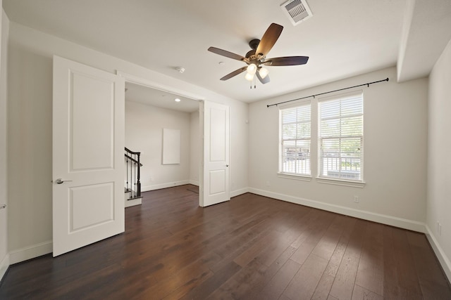 1317 Roy St, Houston, TX 77007 - unfurnished room featuring baseboards, a ceiling fan, dark wood-type flooring, stairs, and a smoke detector