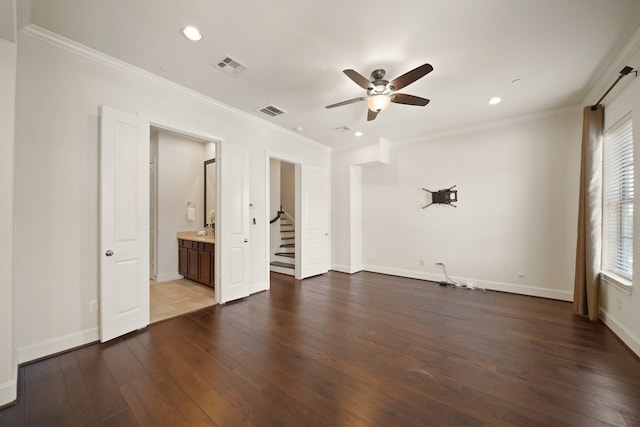 1317 Roy St, Houston, TX 77007 - unfurnished bedroom featuring crown molding, dark wood-style flooring, recessed lighting, baseboards, and connected bathroom