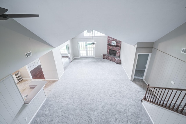 1313 Mcdonald St, Deer Park, TX 77536 - unfurnished living room featuring a ceiling fan, carpet, vaulted ceiling, and a fireplace