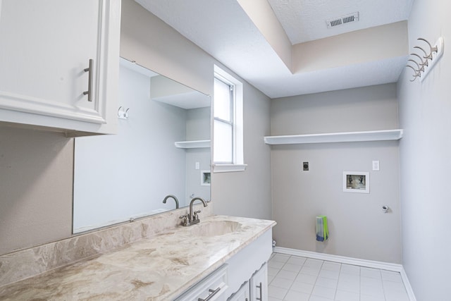 1313 Mcdonald St, Deer Park, TX 77536 - washroom with electric dryer hookup, hookup for a washing machine, light tile patterned flooring, cabinet space, and baseboards