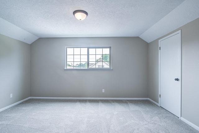 1313 Mcdonald St, Deer Park, TX 77536 - additional living space featuring carpet, vaulted ceiling, a textured ceiling, and baseboards