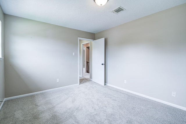 1313 Mcdonald St, Deer Park, TX 77536 - spare room featuring light colored carpet, baseboards, and a textured ceiling