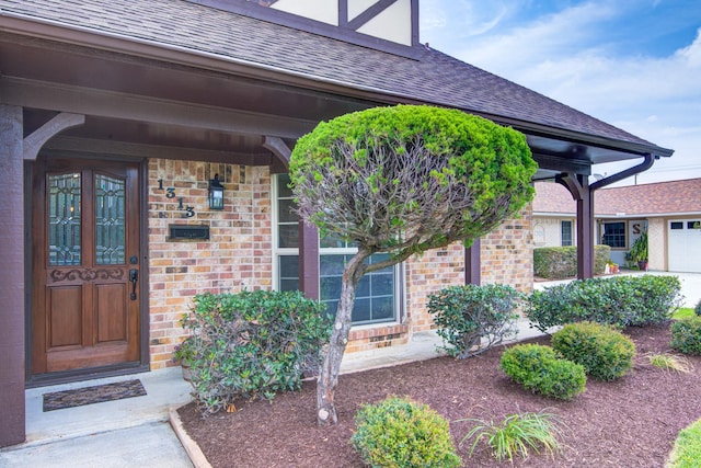 1313 Mcdonald St, Deer Park, TX 77536 - property entrance featuring roof with shingles and brick siding