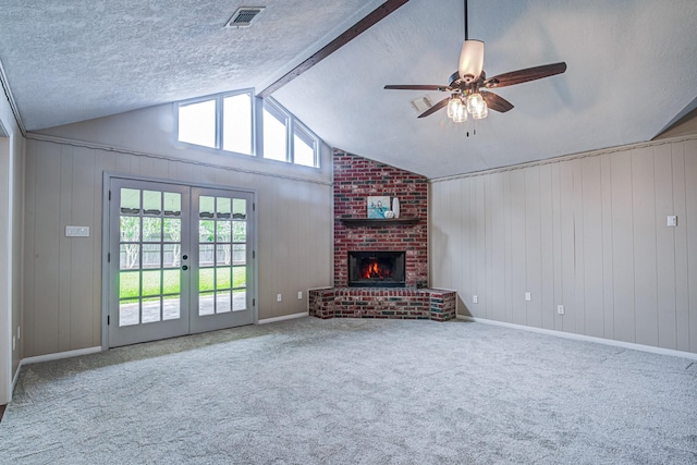 1313 Mcdonald St, Deer Park, TX 77536 - unfurnished living room featuring carpet flooring, a ceiling fan, a fireplace, french doors, and a textured ceiling
