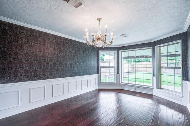 1313 Mcdonald St, Deer Park, TX 77536 - empty room featuring a chandelier, dark wood-type flooring, a textured ceiling, crown molding, and wallpapered walls
