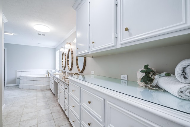 1313 Mcdonald St, Deer Park, TX 77536 - kitchen with white cabinets, light countertops, crown molding, light tile patterned floors, and a sink
