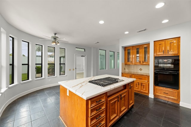 12203 Ashley Circle Dr E, Houston, TX 77071 - kitchen featuring stainless steel gas cooktop, brown cabinetry, ceiling fan, a kitchen island, and recessed lighting