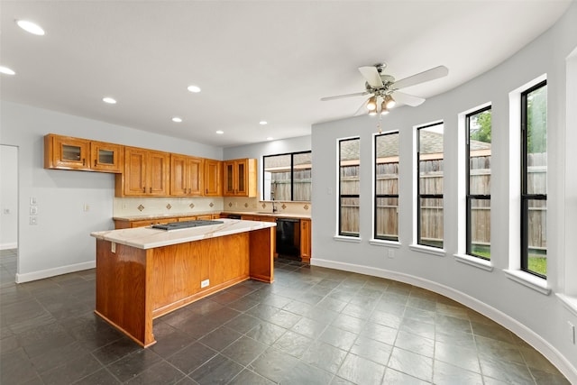 12203 Ashley Circle Dr E, Houston, TX 77071 - kitchen with brown cabinets, a center island, recessed lighting, black dishwasher, and light countertops