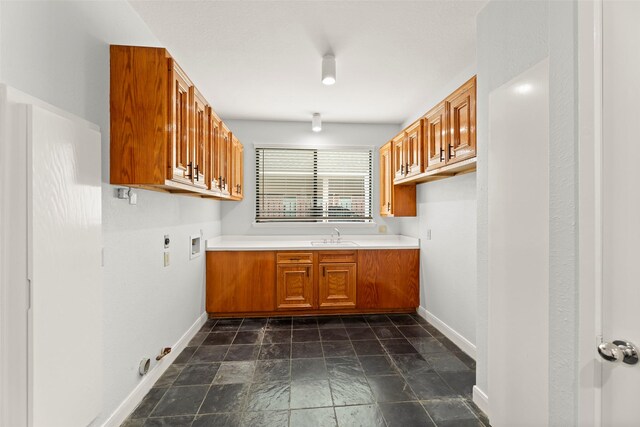 12203 Ashley Circle Dr E, Houston, TX 77071 - laundry room with cabinet space, gas dryer hookup, hookup for an electric dryer, baseboards, and dark stone finish floors