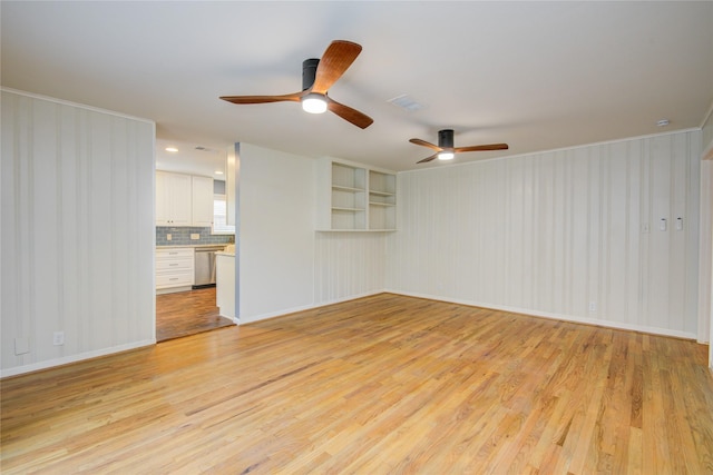 5007 Redstart St, Houston, TX 77035 - unfurnished living room with light wood finished floors, a ceiling fan, baseboards, and crown molding