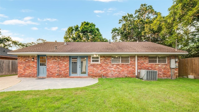 5007 Redstart St, Houston, TX 77035 - back of house featuring central AC, a patio area, brick siding, and a shingled roof