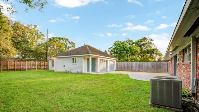 5007 Redstart St, Houston, TX 77035 - view of yard featuring cooling unit, a detached garage, and a patio area