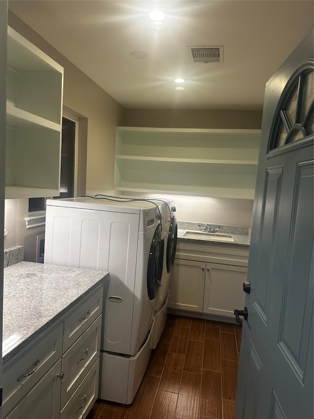5007 Redstart St, Houston, TX 77035 - laundry room with washer and dryer, a sink, dark wood finished floors, and recessed lighting